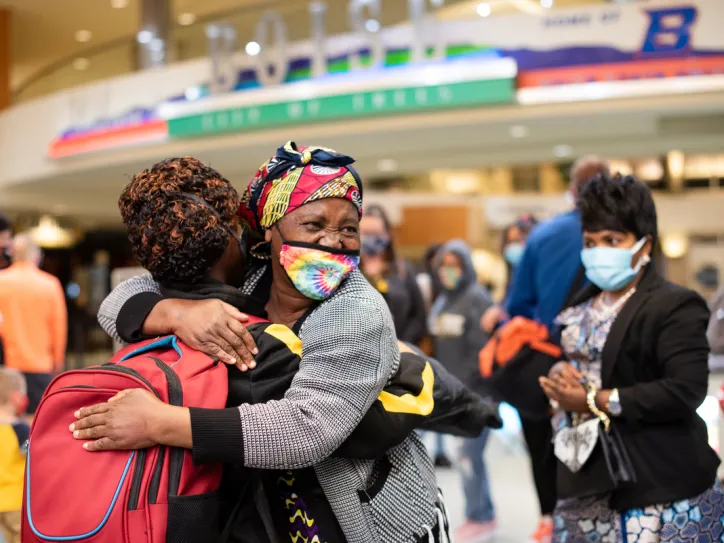 A family reunites and hugs in the Boise airport