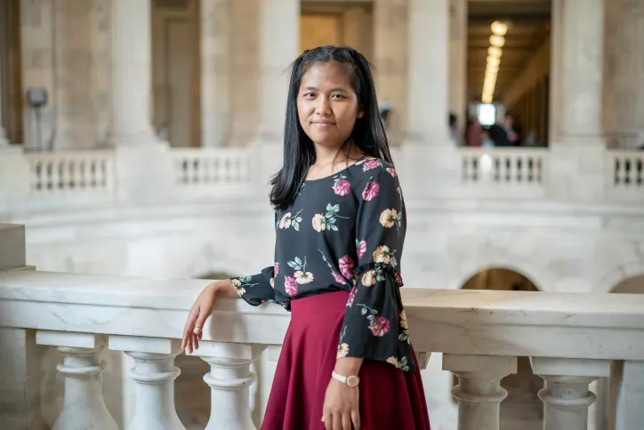 A woman from Atlanta stands inside the Washington, DC, Capitol. She is there to represent refugee voices.