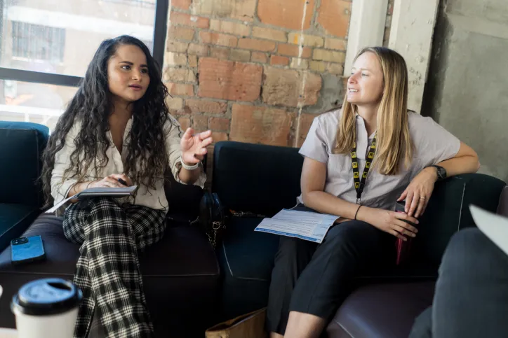An IRC staff member and client sit together to discuss finance tools for small business owners