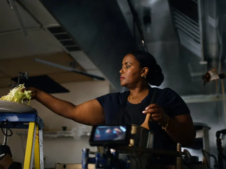An IRC client prepares food in her restaurant 