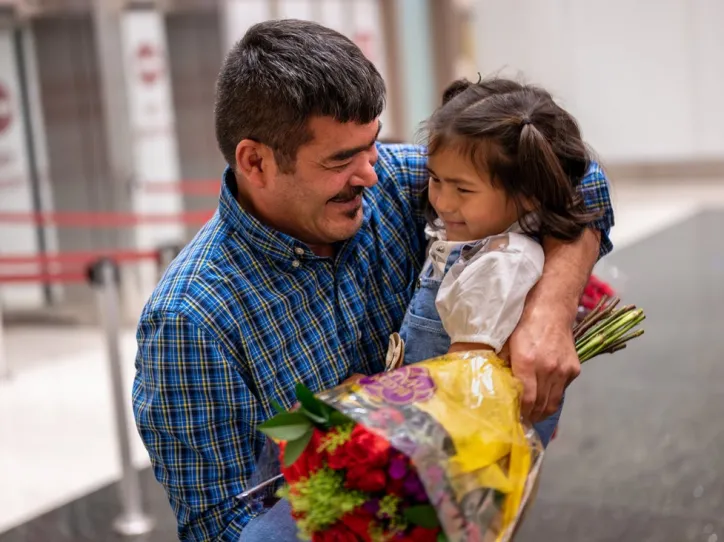 A man reunites with his daughter at the airport