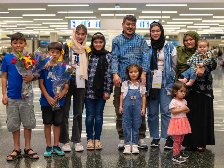 A family reunites and stands together at the Salt Lake City airport