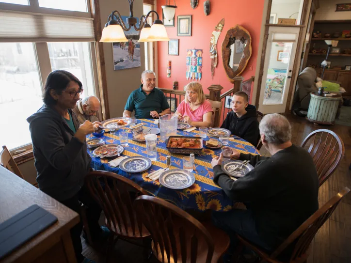 A family gathers around a table for a meal in Wichita