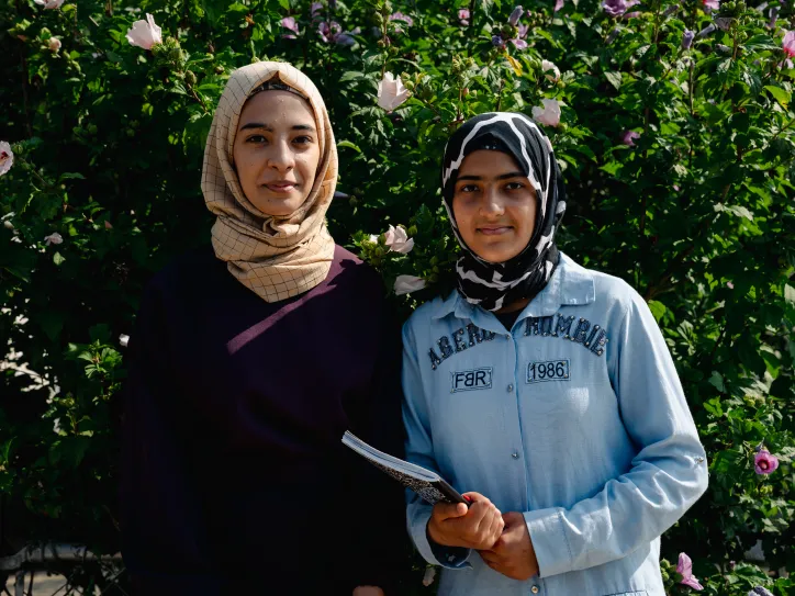 Two sisters stand in front of Silver Spring's Summer Academy