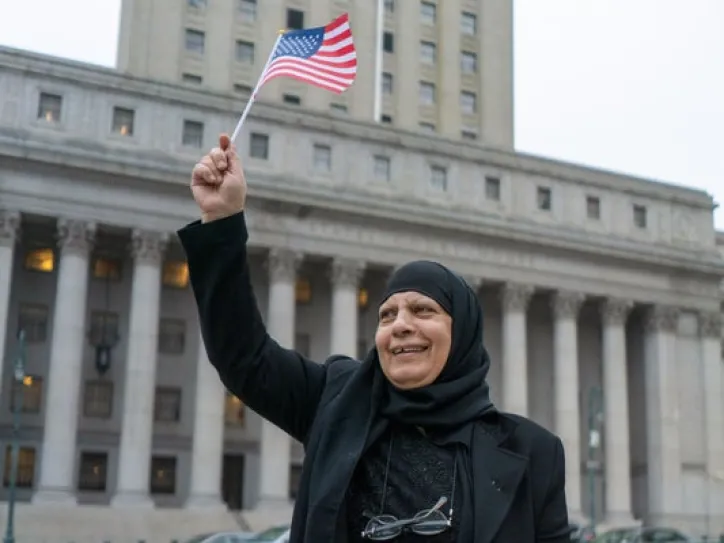A woman holds an American flag
