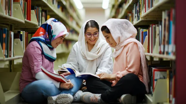 Afghan college students read books in university library