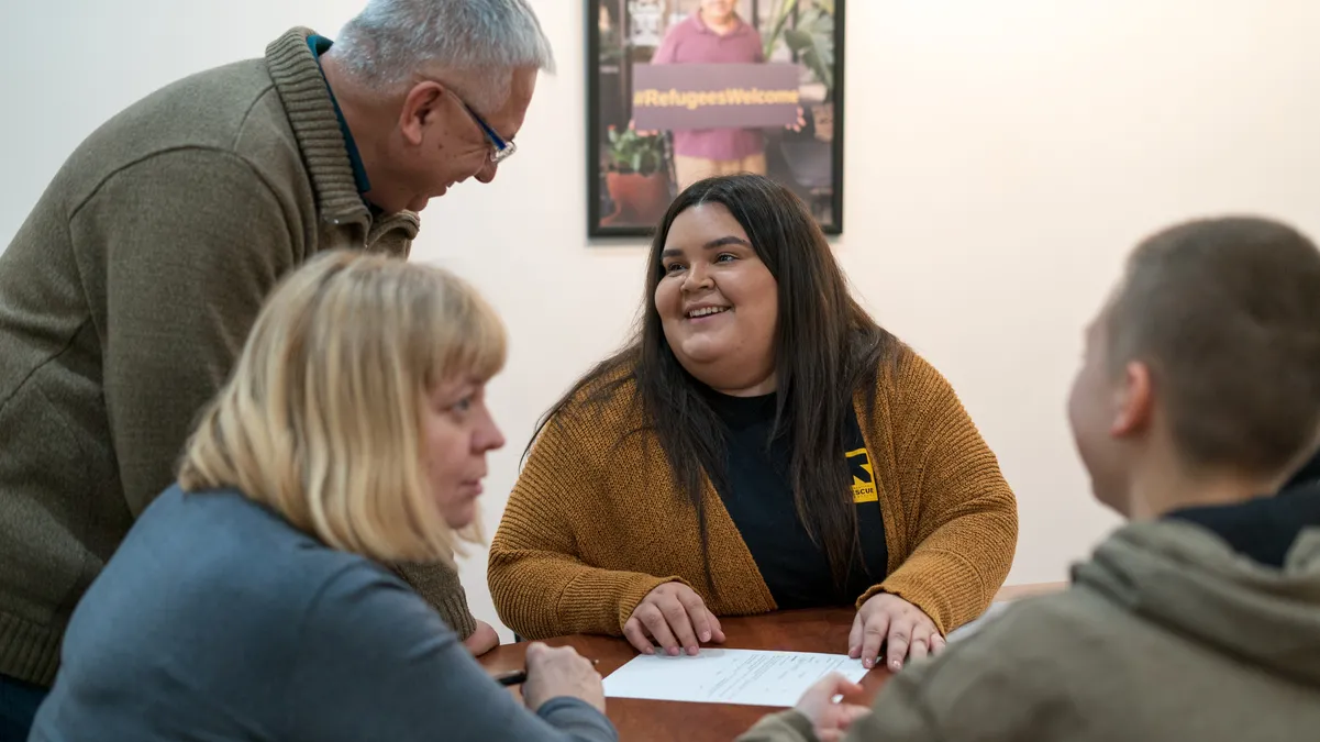 IRC clients and an IRC staff member discuss services the IRC can offer to eligible clients
