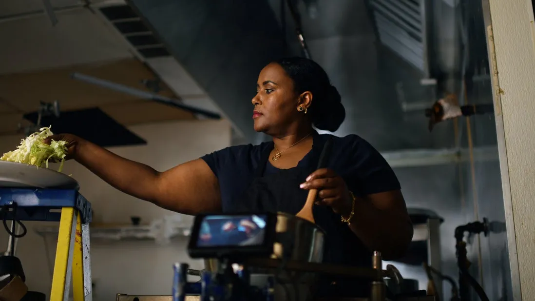 An IRC client prepares food in her restaurant 