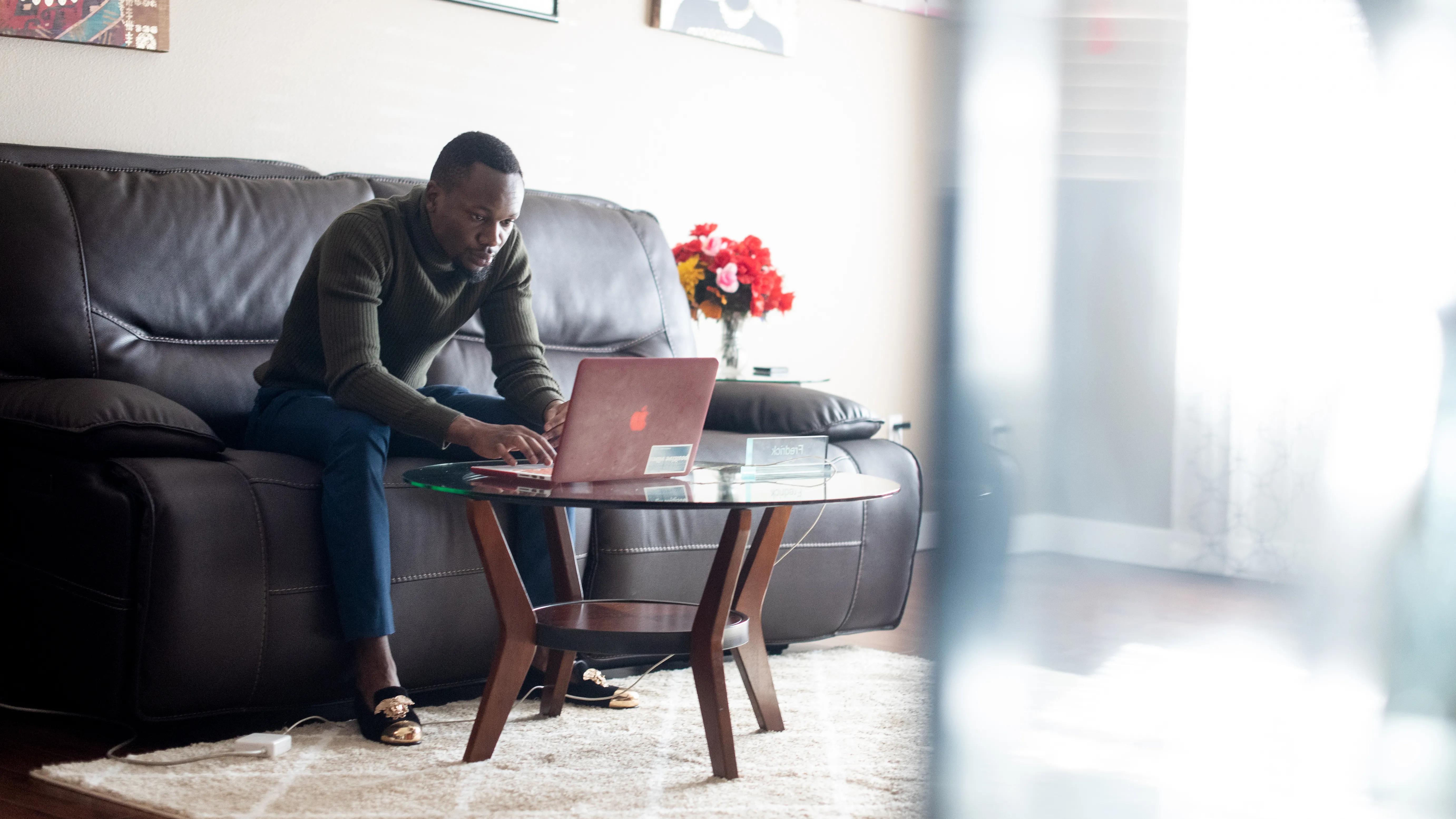 A man types on a laptop computer as part of an employment program