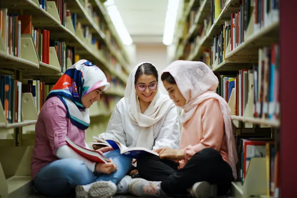 Afghan college students read books in university library
