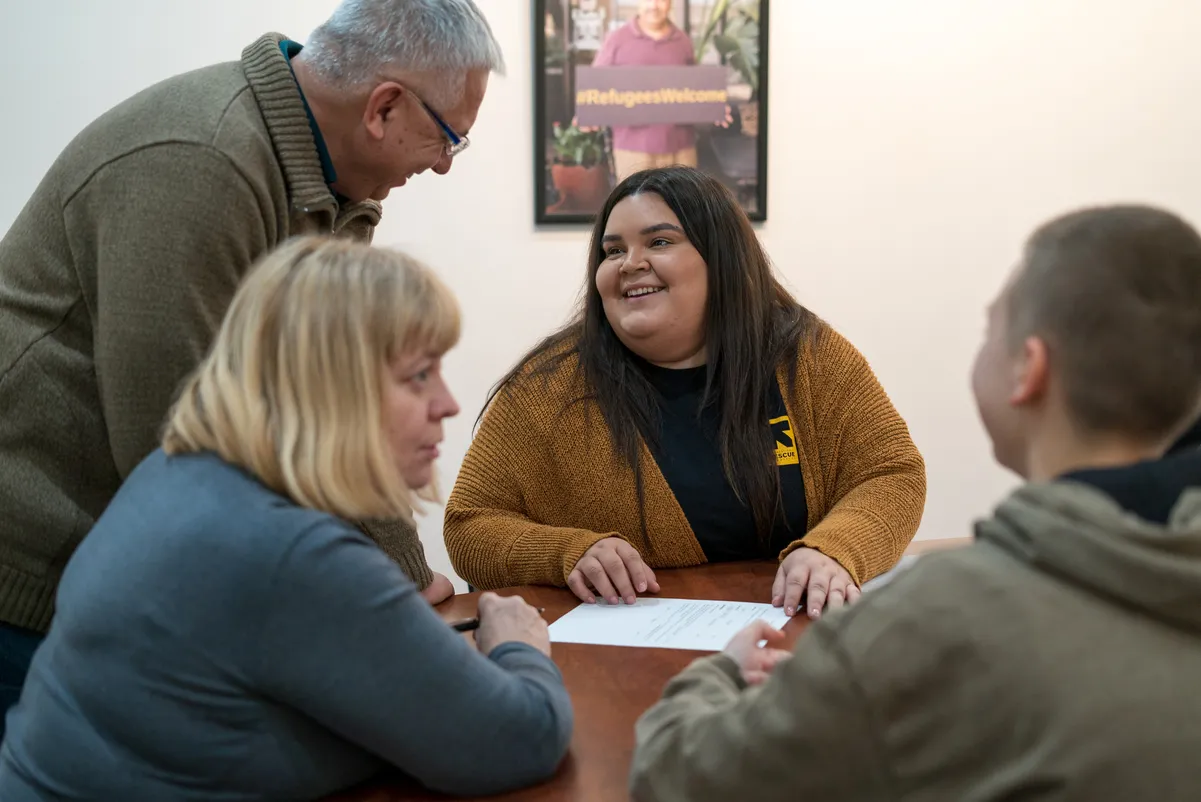 IRC clients and an IRC staff member discuss services the IRC can offer to eligible clients