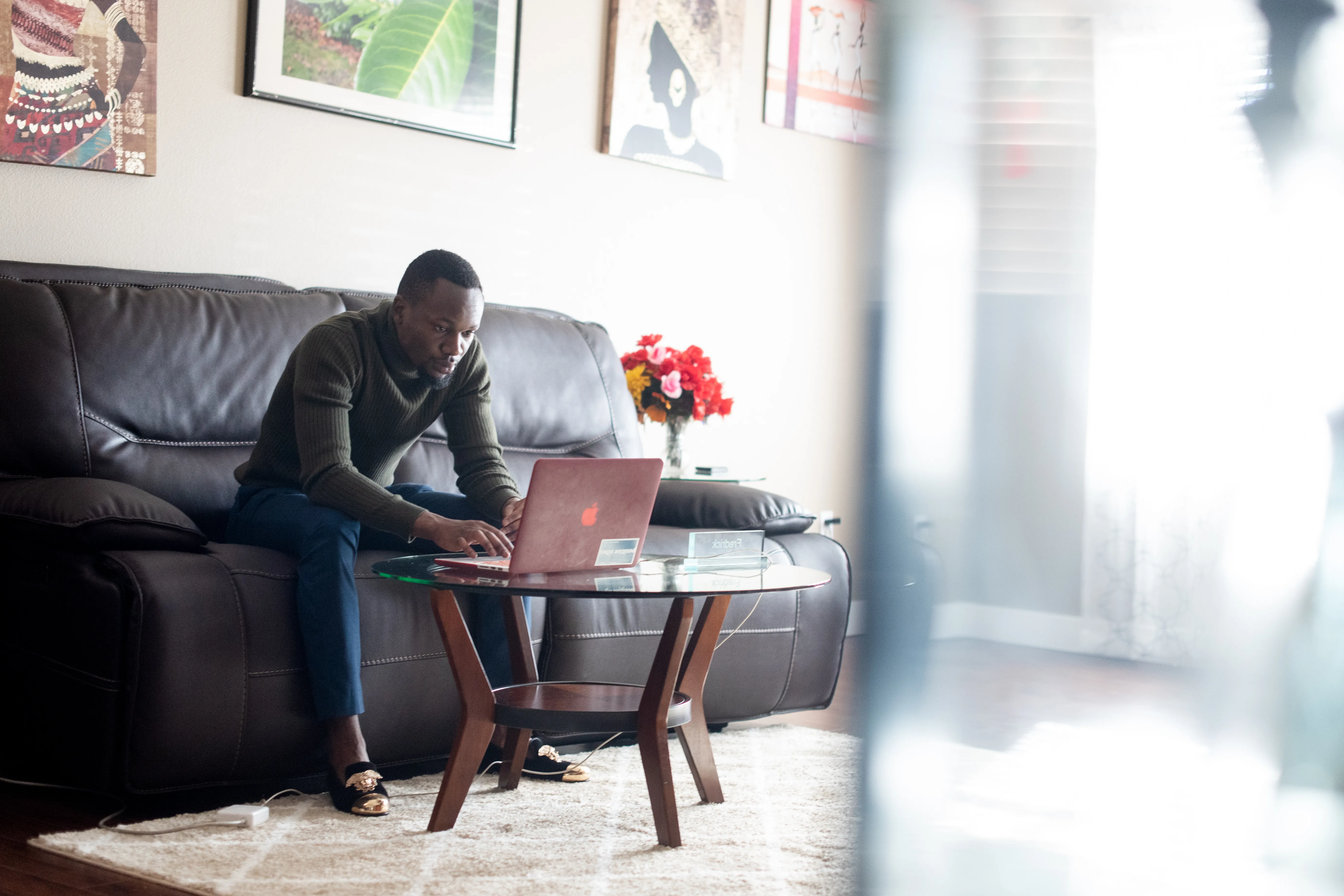A man types on a laptop computer as part of an employment program