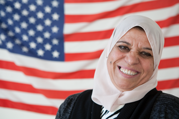 Happy woman with U.S. flag in the background