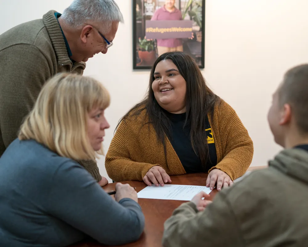 IRC clients and an IRC staff member discuss services the IRC can offer to eligible clients