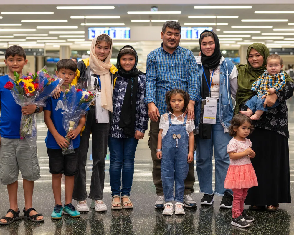 A family reunites and stands together at the Salt Lake City airport